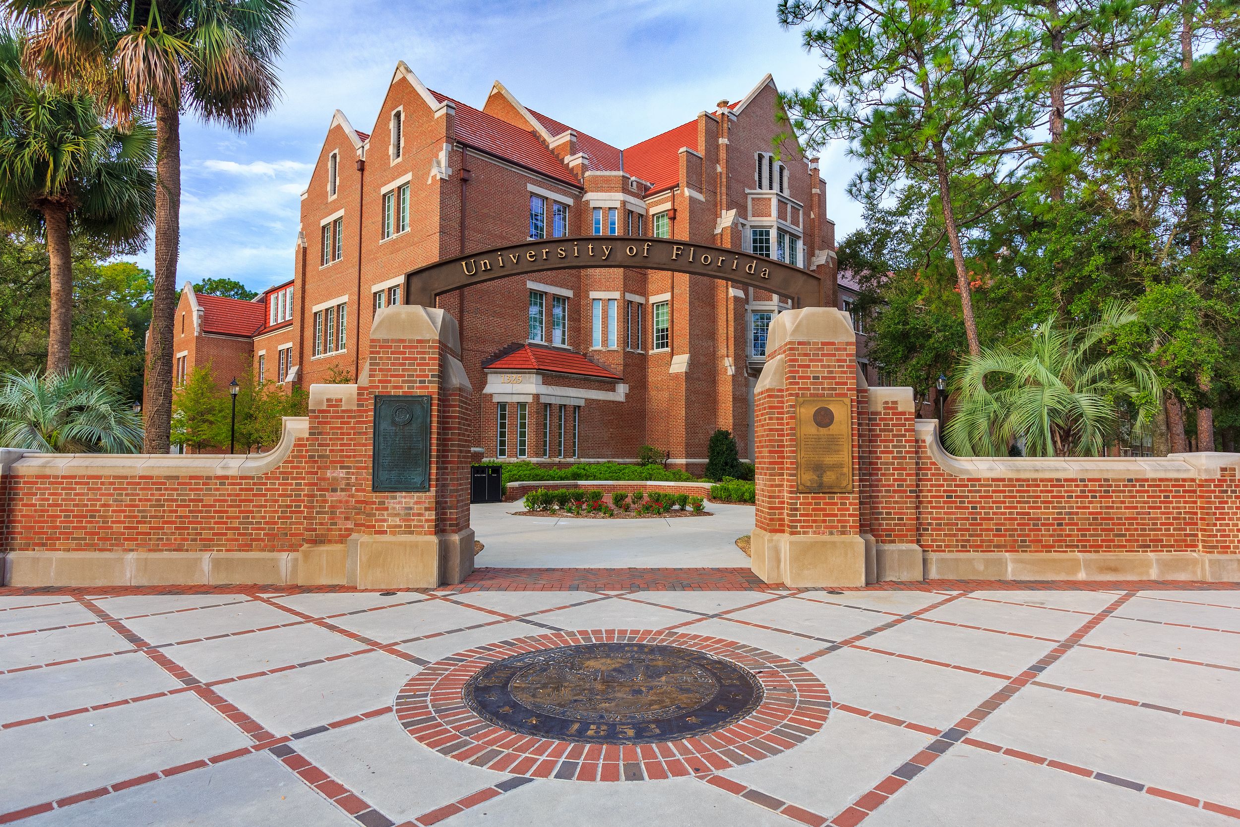 A building from the University of Florida with a sign for the school in the foreground.